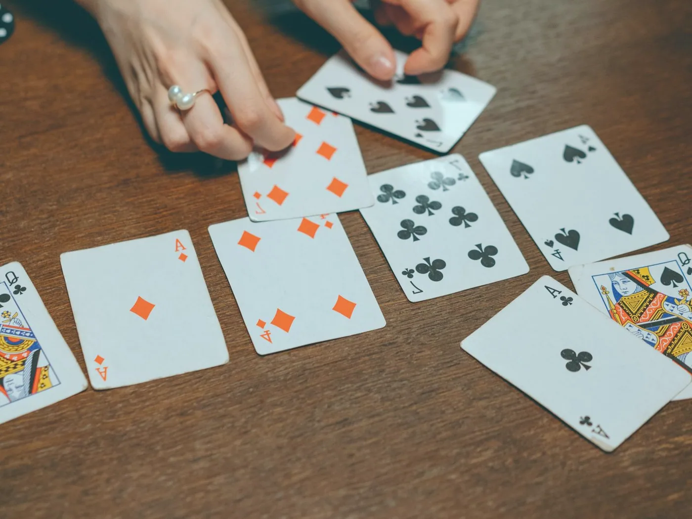 Hand of poker among friends dealt on felt